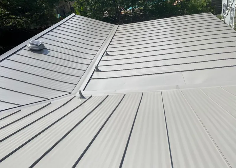 Solar attic fan installed on a metal roof for Roof Ventilation in Reston
